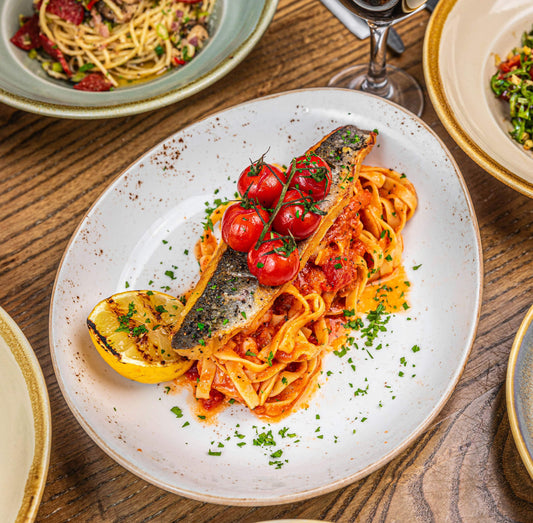 Mediterranean-style sea bass with crispy skin and tomato tagliatelle